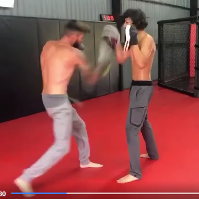 boxing and coaching happening live on the matts with two sparrers in motions